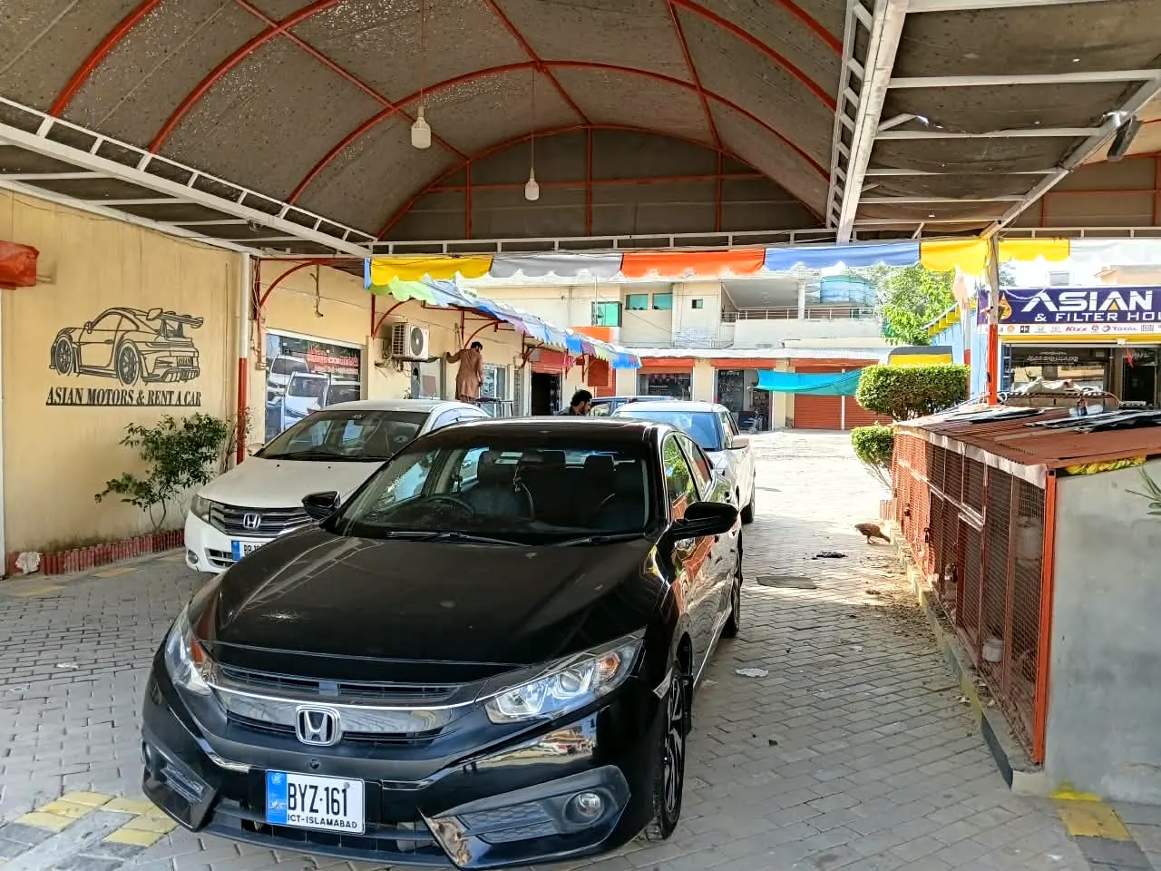 Black Honda Civic at the Asian Motors and Rent A Car showroom