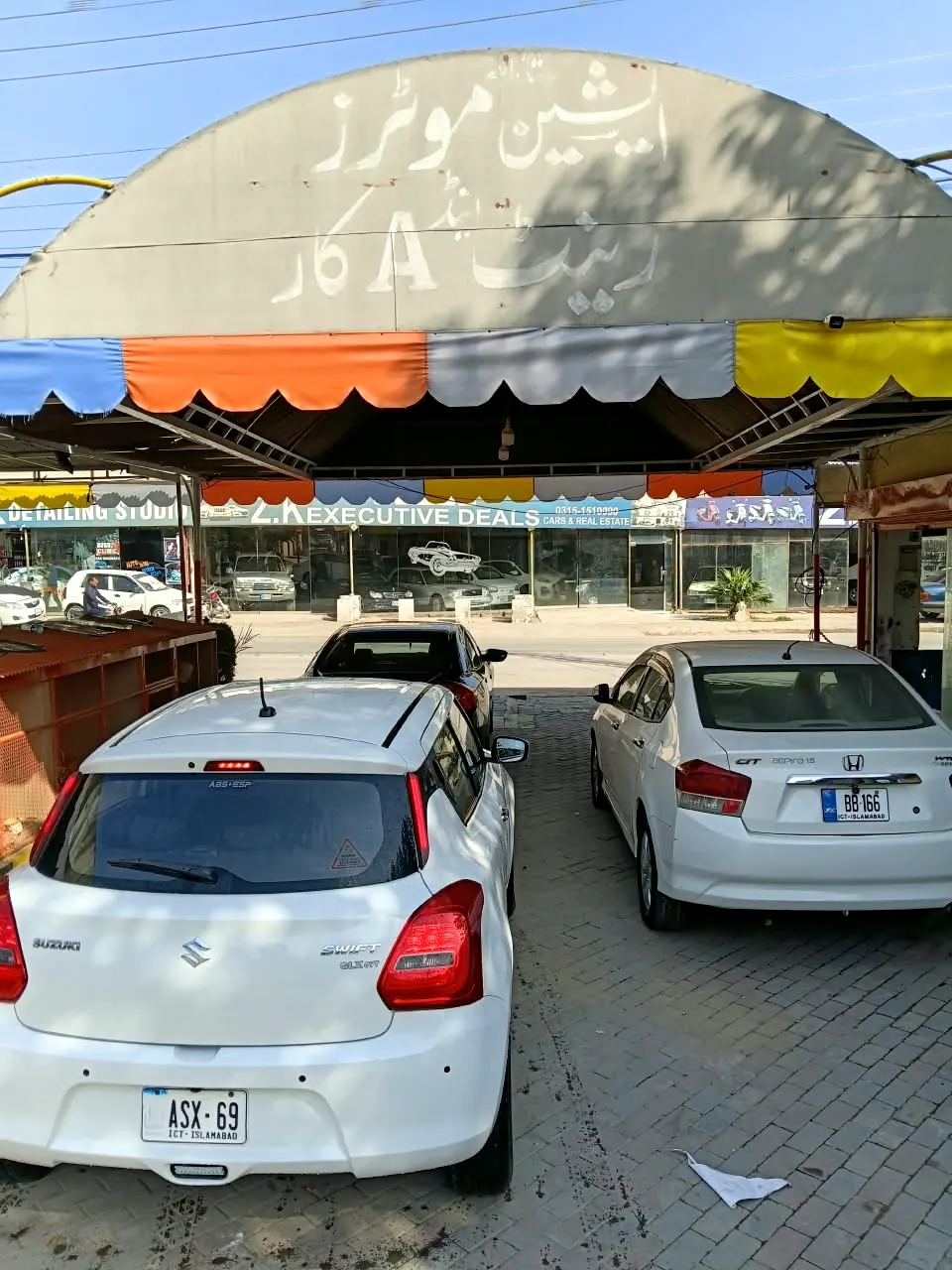 Cars under the Asian Motors canopy