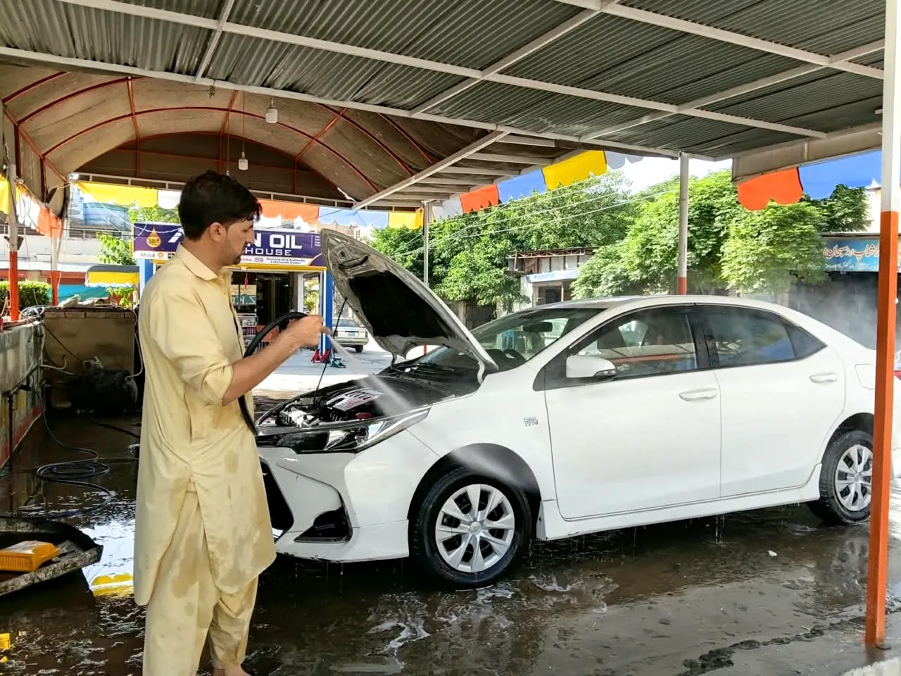 Washing a white Toyota Corolla at Asian Car Wash